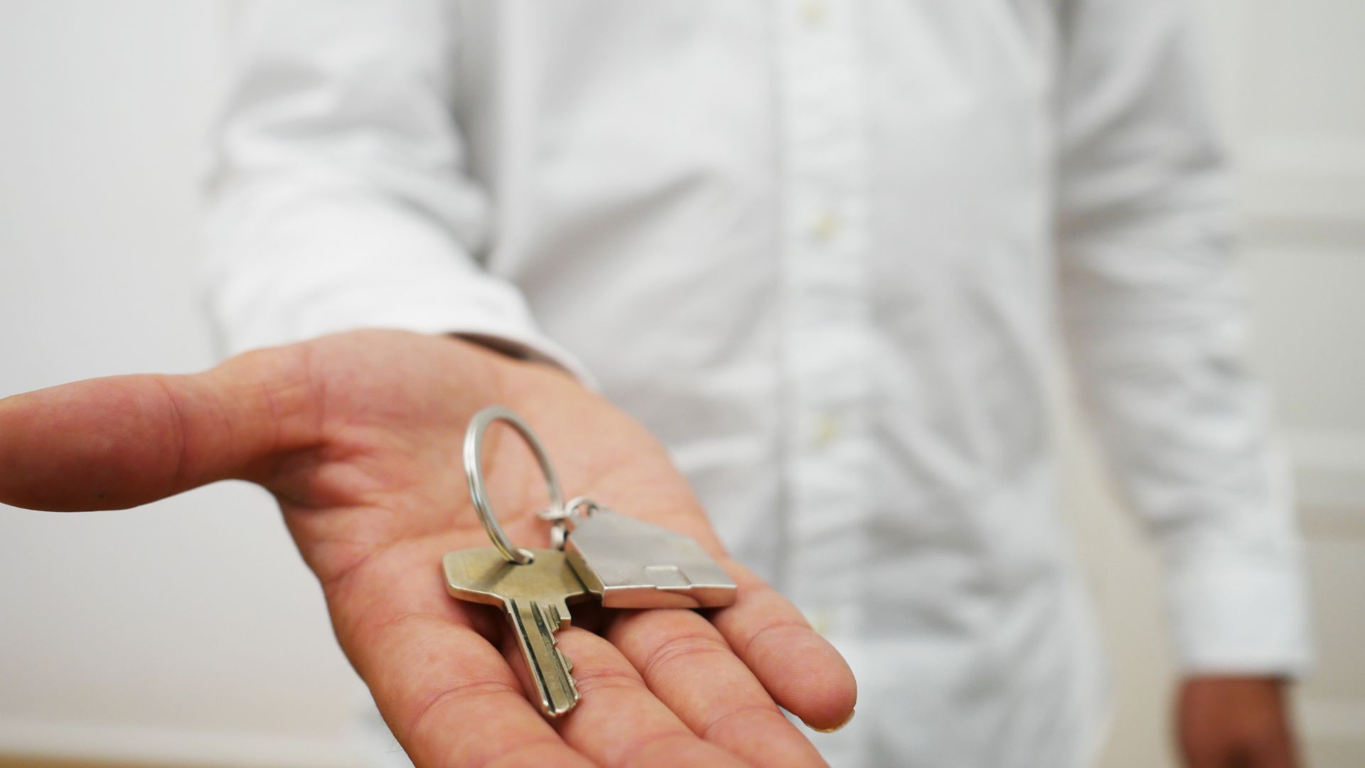 man holding a key in his palm